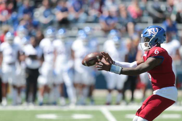 Kansas junior quarterback Jalon Daniels (6) receives the ball during Saturday's spring game at David Booth Kansas Memorial Stadium.